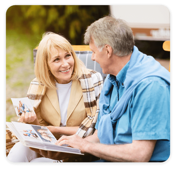 Mature couple looking at photos in family album